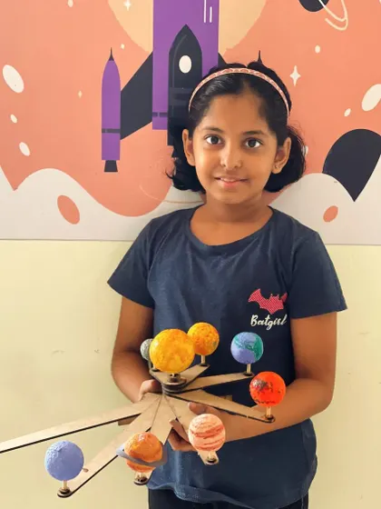Another happy camper with her beautifully crafted solar system model.