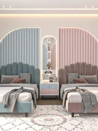 For this shared children's room, we used a symmetrical design with distinct color zones to give each child their own sense of space. The scalloped, upholstered headboards in pastel blue and pink add a touch of playful elegance.