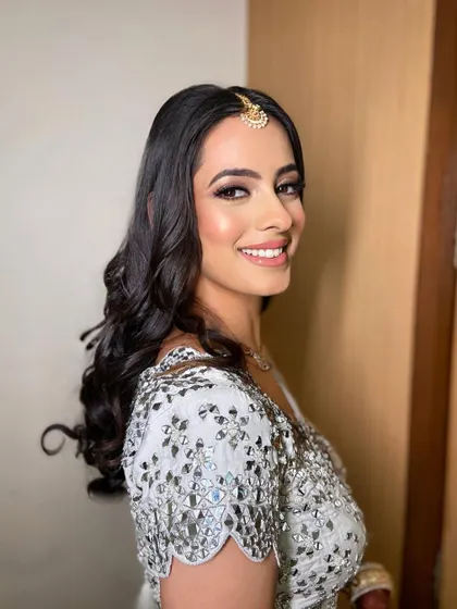 Nothing beats a soft, natural glam look. For this sangeet, I created a classic smokey eye with a nude lip, letting her sparkling white outfit do the talking.