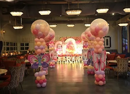 We extended the butterfly theme throughout the venue with these beautiful balloon pillars topped with large butterfly cutouts, creating a cohesive and magical atmosphere.