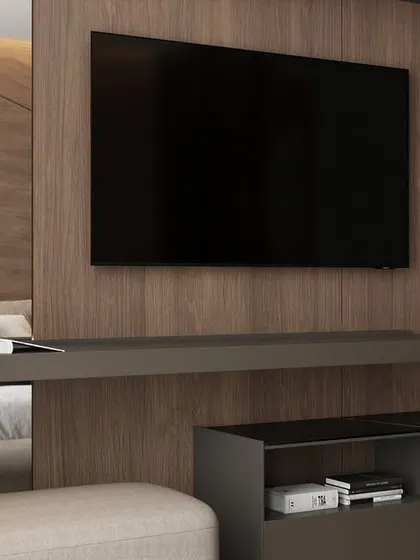 A close-up of the integrated TV and console unit in the modern bedroom, showcasing the clean lines and functional design.