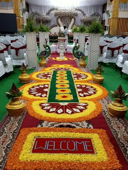 A detailed view of the traditional floral rangoli pathway. The use of marigolds, roses, and other petals creates a stunning visual welcome for guests.