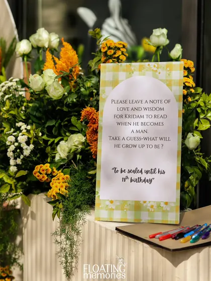 We love incorporating interactive and sentimental details. For this safari-themed first birthday, we set up a station for guests to leave a 'note of love and wisdom' for the baby to read on his 18th birthday.