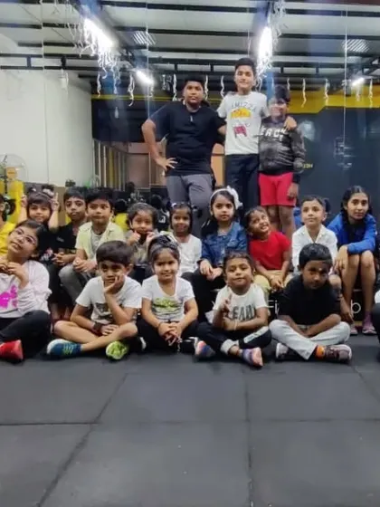 A relaxed group photo of our kids' batch after a class during the Christmas season. You can see the festive decorations in the background.