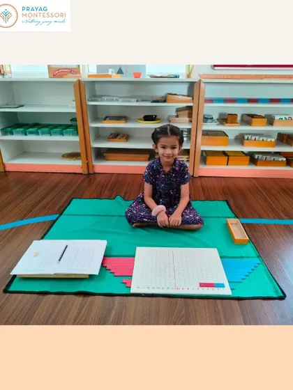 A student works with the Addition Strip Board, a classic Montessori tool that makes the abstract concept of addition concrete and understandable.