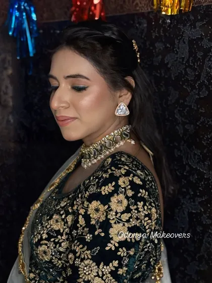 A side profile showing the soft, shimmery eyeshadow and the perfectly blended skin. This is a great look for any festive occasion.