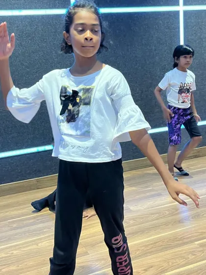A student practicing her moves during a class. Consistent practice is the key to success, and I guide my students every step of the way.