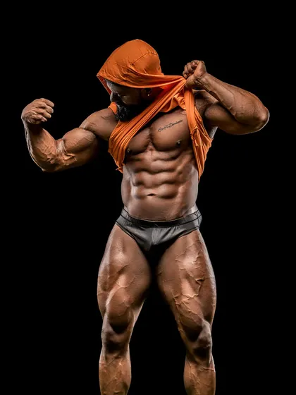 The hooded look, a classic in bodybuilding photoshoots. It creates a mysterious and powerful aesthetic, highlighting the physique.