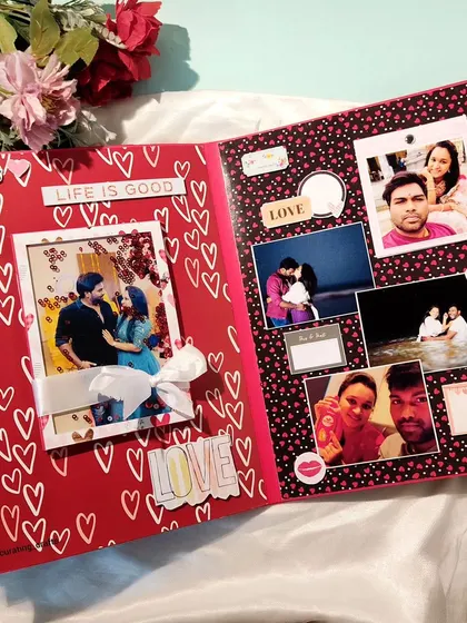 This scrapbook page is filled with love, using a red and black heart pattern as the background for cherished couple photos.