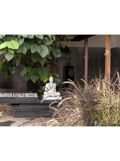 A pebble court provides a serene space for contemplation. The landscape design for the museum incorporates a variety of textures and materials to define different zones.