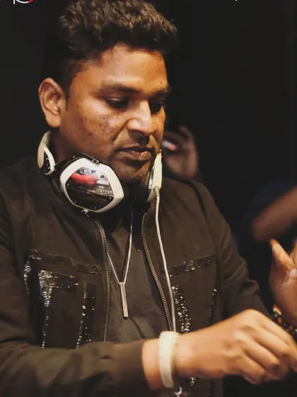 A close-up, focused shot while mixing. You can see the concentration it takes to blend tracks seamlessly and build a narrative.