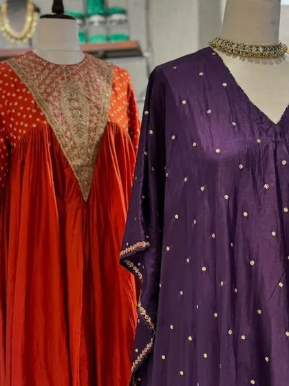 A close-up of the beautiful details on these festive suits. The polka dots and embroidered necklines add a touch of playful elegance.