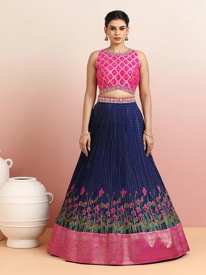 The full view of the navy and pink lehenga, showcasing the rich zari border and the contemporary cut of the blouse.