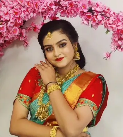 A lovely, gentle portrait. Her expression is soft and happy, and the makeup enhances her natural beauty perfectly.