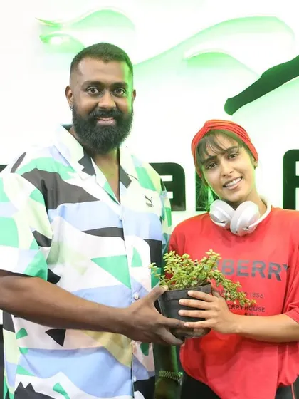 A guest receives a welcome plant from our head coach.