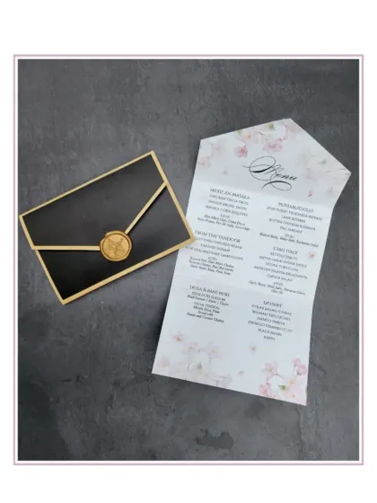 An elegant menu card designed to look like a sealed letter. The floral-printed menu is held within a black and gold laser-cut sleeve, complete with a faux wax seal.