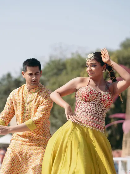The couple showing off their dance moves. Mishi's makeup was designed to be sweat-proof and long-lasting, perfect for a performance.