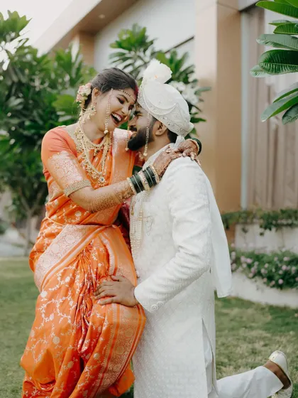 A moment of pure, uninhibited joy. The groom lifts his bride as they both share a laugh, a perfect example of the unposed, happy moments I love to capture.