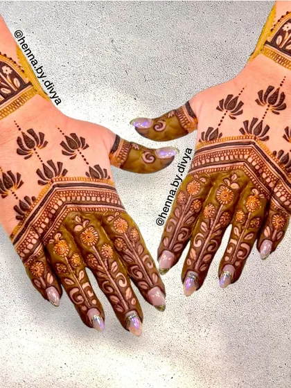 A unique design where the back of the hand is covered in floral patterns, while the front features minimalist lotus motifs. It's a great example of how different styles can be combined.