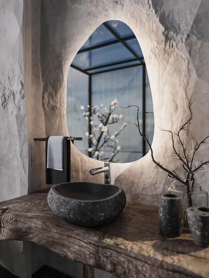 For this powder room, we aimed for a dramatic, nature-inspired look. The walls have a rough, stone-like texture, contrasted with a rustic wooden countertop and a carved stone basin. The organic-shaped, backlit mirror adds a soft, modern glow to the raw and earthy space.