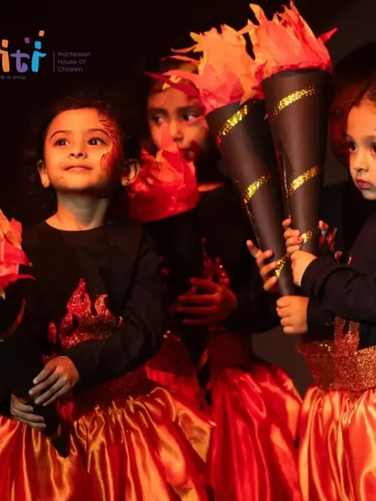 Children hold their flame-tipped torches, their faces painted to resemble fire. The attention to detail in costumes and makeup is remarkable.