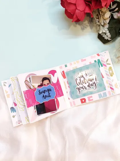 A page celebrating a couple, Soumya and Amit, within a mini birthday scrapbook.