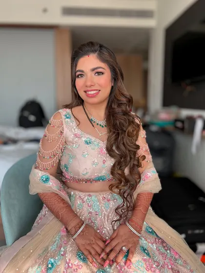 This bride's reception look was all about pastel glam. Her colorful lehenga was the inspiration for the soft, shimmery eye makeup and glowing skin.