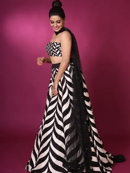The chevron lehenga styled with a simple black net dupatta. This shows how a simple addition can change the feel of the outfit, making it suitable for different occasions.