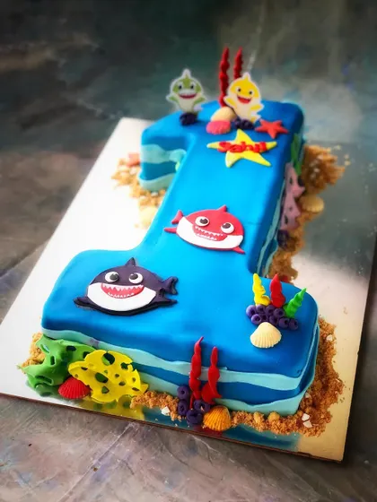 Another angle of our Baby Shark number cake shows the birthday shape and sea-themed decorative details.