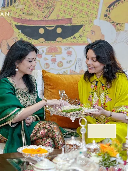 The joy of togetherness this Diwali. Two friends share a moment of celebration, with my elegant silverware and festive decor creating a warm and inviting atmosphere for their gathering.