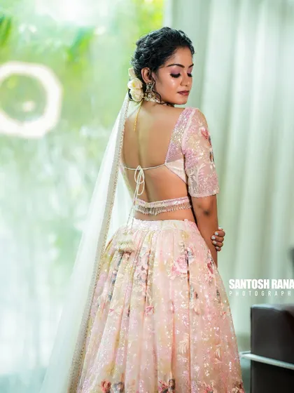 A full view of the back of the lehenga, showing the tie-up detail of the blouse and the elegant drape of the dupatta.