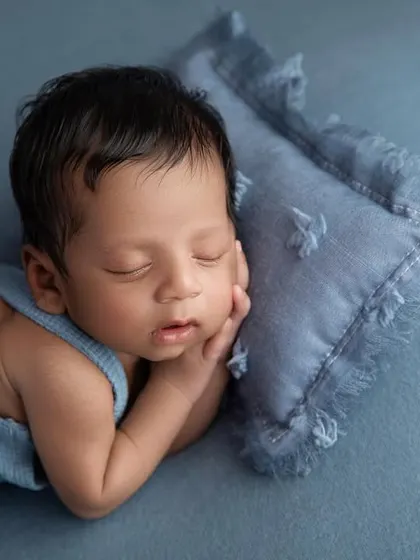 Adding a small pillow gives the baby a comfortable place to rest his head, creating a slightly different look for the side pose.