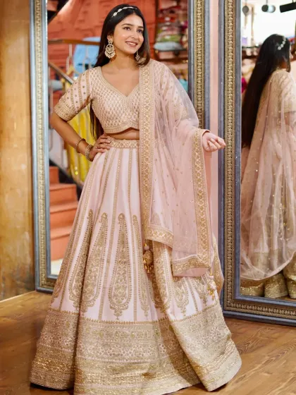 Pastel lehengas are such a vibe for day weddings or your engagement. This soft pink lehenga with detailed golden embroidery is the definition of elegance and grace, giving you a soft, romantic look.
