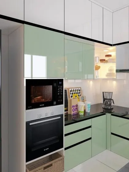A U-shaped modular kitchen with light green lacquered glass cabinets and built-in appliances. The design is clean, modern, and highly functional.