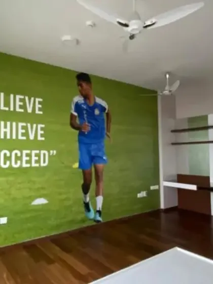 A personalized sports-themed mural for a young football enthusiast, featuring a life-sized player and a motivational quote to inspire them to "Believe, Achieve, Succeed."