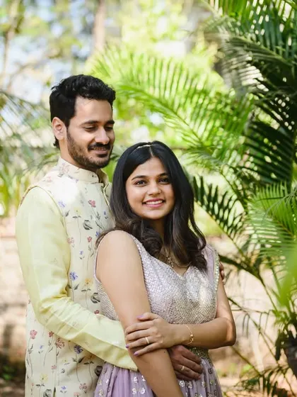 A lovely portrait of the newly engaged couple, Srushti and Akshay, surrounded by lush greenery. They look so happy and comfortable together.