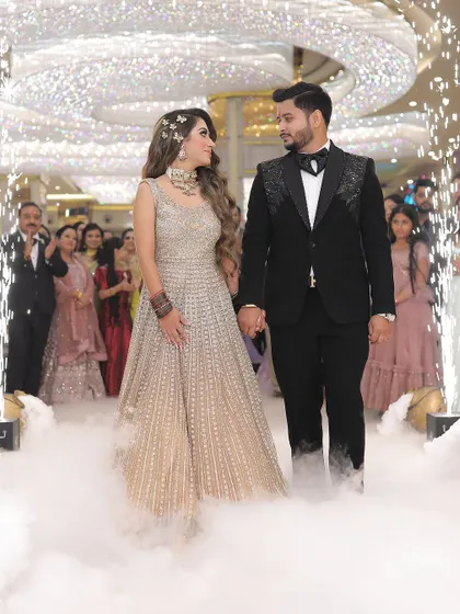 The grand entrance of the couple at their reception, complete with cold pyro and smoke effects. We are equipped to capture the scale and excitement of large-scale wedding celebrations.