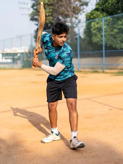 Getting ready to bat. The focus and preparation before the action are just as important as the action itself.