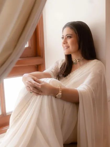 Another beautiful shot from this series, showcasing the classic elegance of the white saree. The styling is minimal to let the wearer's grace and the outfit's simplicity shine.