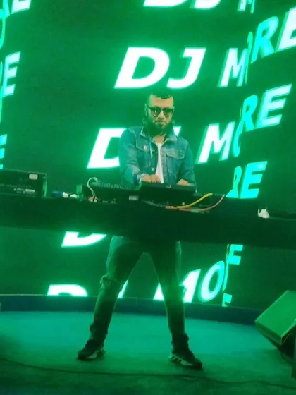 The stage is bathed in green light as I control the music. The visual setup is just as important as the audio for a full sensory experience.