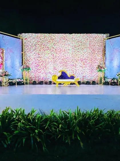 The lighting on this stage highlights the texture of the flower wall and the beautiful marble-effect side panels.