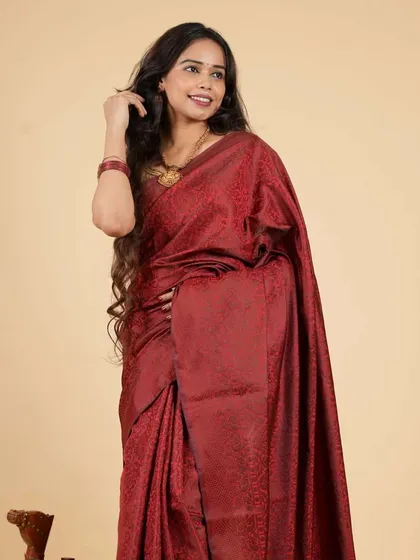 A deep maroon saree in a rich, textured fabric, pre-stitched for your convenience. This piece offers a sophisticated and elegant look that is easy to achieve and comfortable to wear all day long.