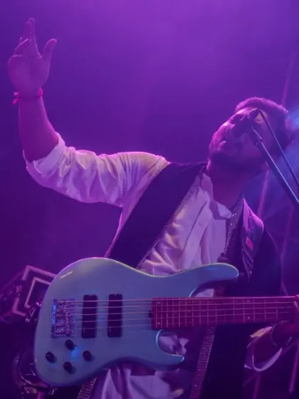 Our bassist, bathed in purple light, adding to the cool, sophisticated vibe of the corporate event.