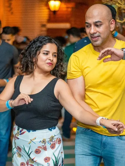A close and connected dance, with both partners smiling.