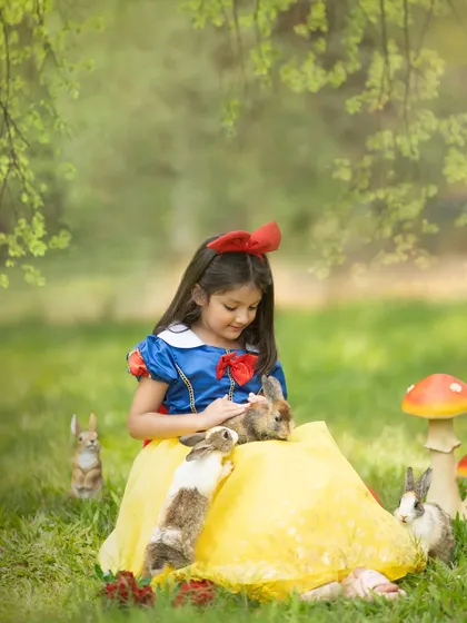 A tender moment between Snow White and a woodland friend. Using live animals (safely, of course) adds an extra layer of magic to our photoshoots.
