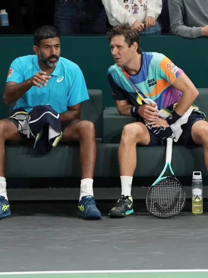 Discussing strategy with my partner during a changeover at the Paris Masters. Communication and tactical adjustments are crucial in doubles.
