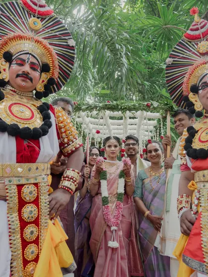 The bride's grand entrance led by Yakshagana performers. Incorporating traditional art forms like this creates a majestic and culturally rich spectacle that leaves a lasting impression on guests.