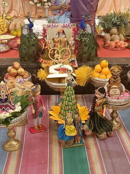 A full platter setup on a colorful striped floor, ready for a traditional ceremony.