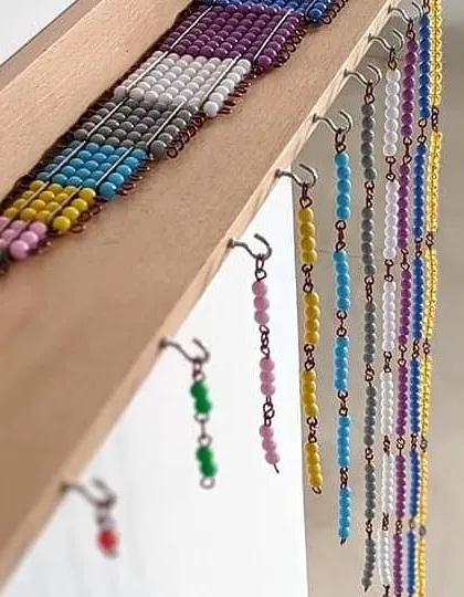 Our hanging bead stair is a fundamental part of the Montessori math curriculum. It provides a visual and tactile way for children to understand the decimal system and the relationships between numbers from one to ten.