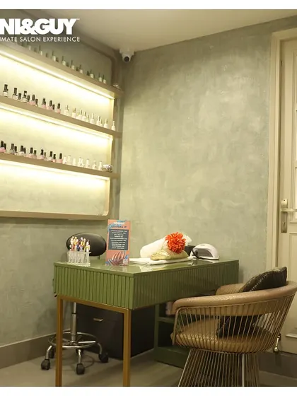 My nail station at the Greater Kailash 1 salon is a dedicated space for creativity and precision. The area is clean, organized, and features back-lit shelves showcasing a wide array of color options.
